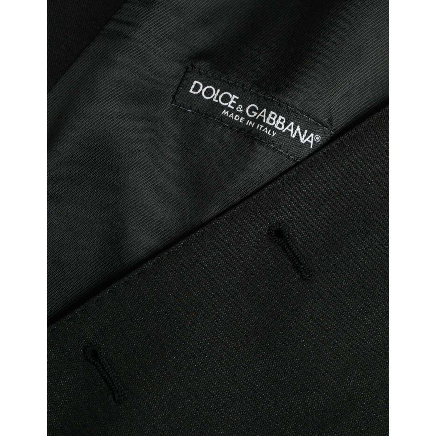 Close-up of Dolce & Gabbana black wool waistcoat dress label with logo detail, showing buttonholes and Made in Italy tag.