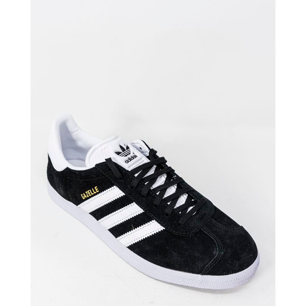 Adidas Gazelle BB5476 black sneakers with white stripes, made from polyurethane, featuring a rubber sole for grip and comfort.