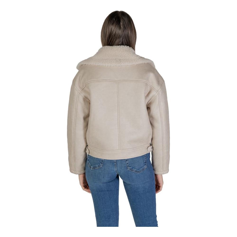 Woman wearing a Vila Clothes beige artificial leather jacket and coat, showcasing fall/winter fashion with faux leather composition.