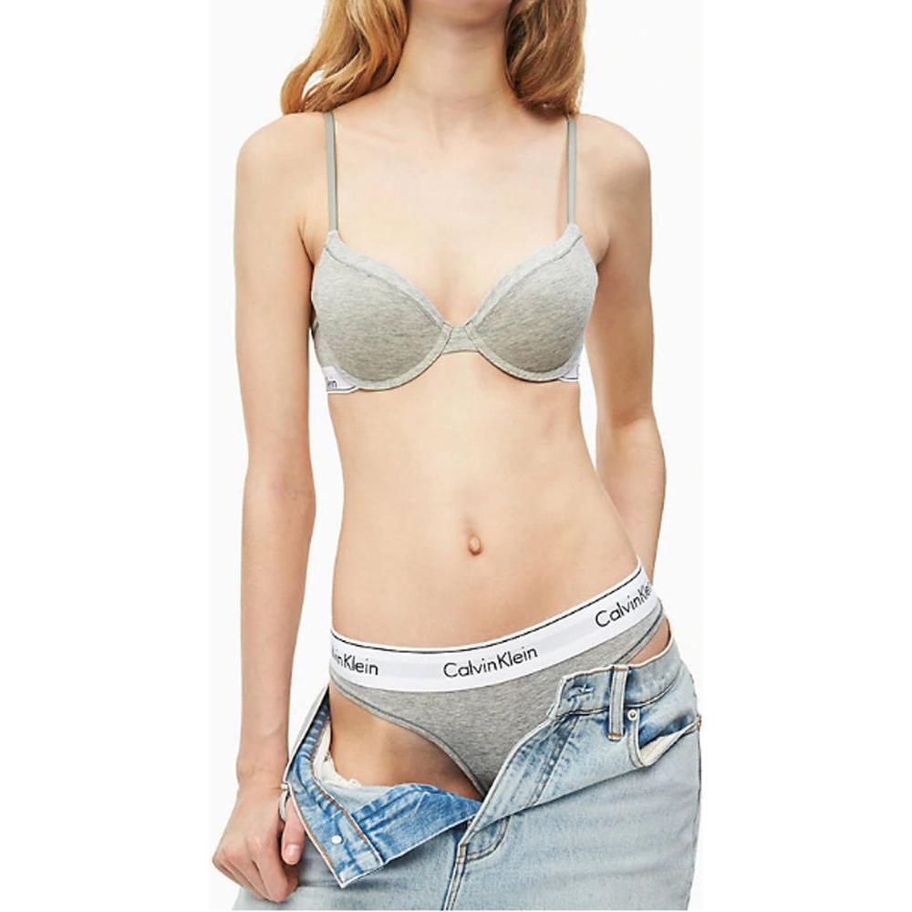 Calvin Klein gray cotton underwear, featuring a breathable thong design, worn by model with denim jacket for casual style.