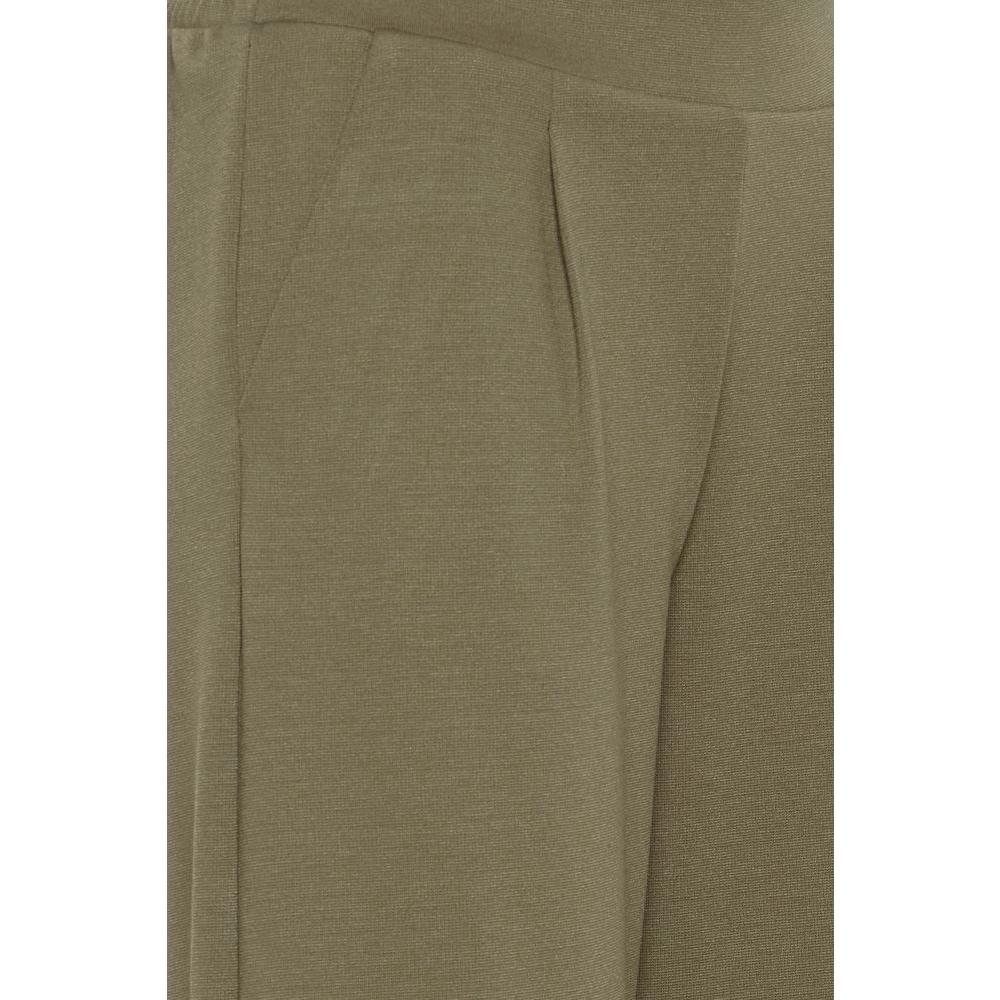 Close-up of ICHI green bootcut pants made from recycled polyester, showcasing the fabric texture and stitching details.