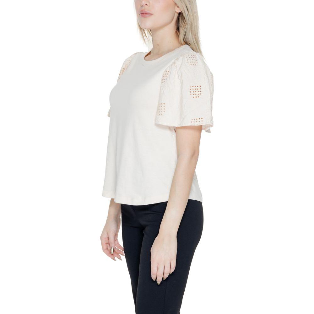 Jacqueline De Yong white cotton top with short sleeves, part of the Spring/Summer collection, model wearing black pants, side view.