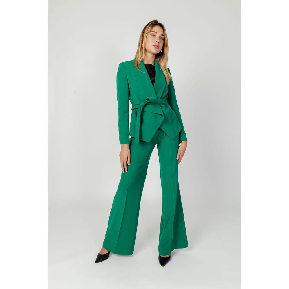Woman wearing Sandro Ferrone green polyester suit and blazer, part of the Autumn/Winter women's jacket collection.