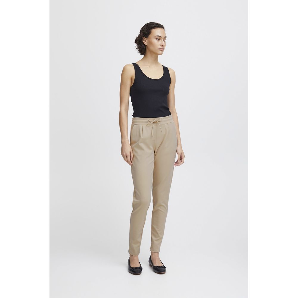 Model wearing ICHI Beige Polyester Pants, mid-rise with drawstring, showcasing slim fit and modern style for women's fashion.