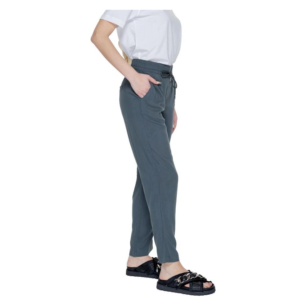 Woman wearing Street One green viscose pants, spring/summer collection, showcasing casual style and comfort.