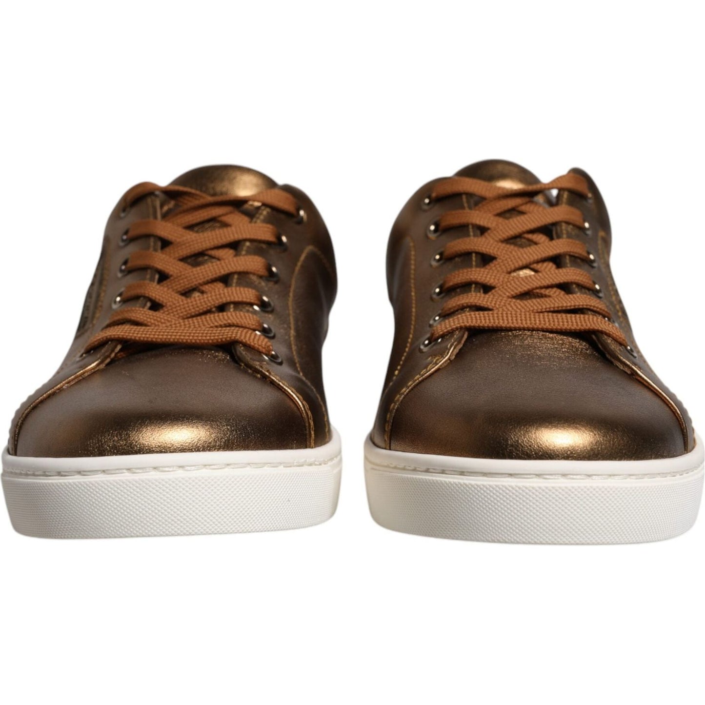 Dolce & Gabbana gold metallic sneakers with white rubber sole and lace-up closure, featuring logo details, front view.