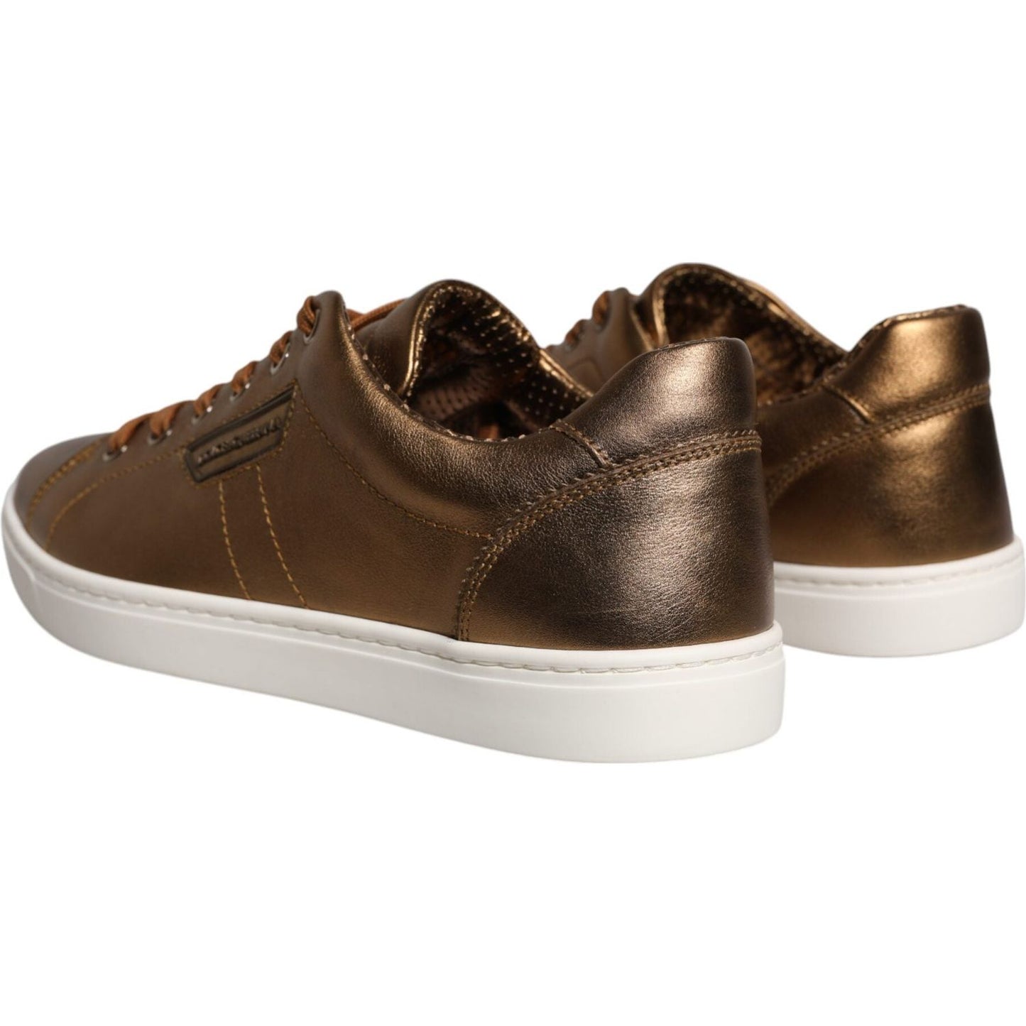 Dolce & Gabbana gold metallic leather men's sneakers with white rubber sole, featuring lace-up closure and logo details, side view.