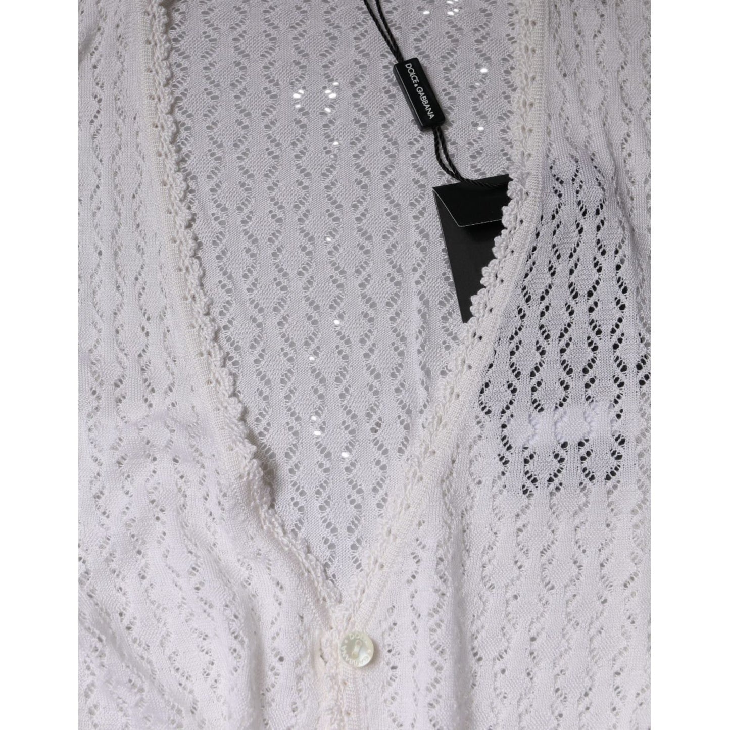 Dolce & Gabbana white silk cardigan with v-neck and button-down closure, featuring a lightweight, knitted design with tags visible.