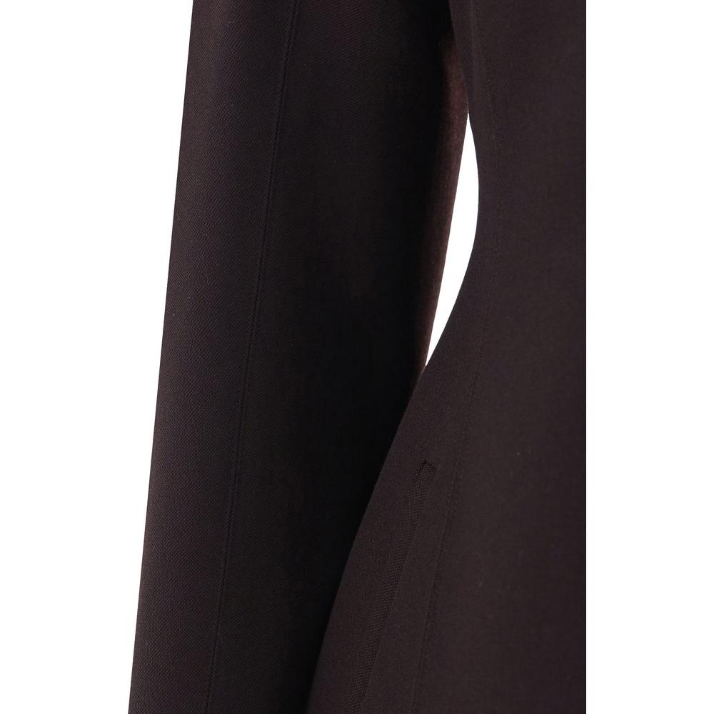 Close-up of black Fendi virgin wool jacket showing shawl lapels and side welt pocket with monochrome pattern.