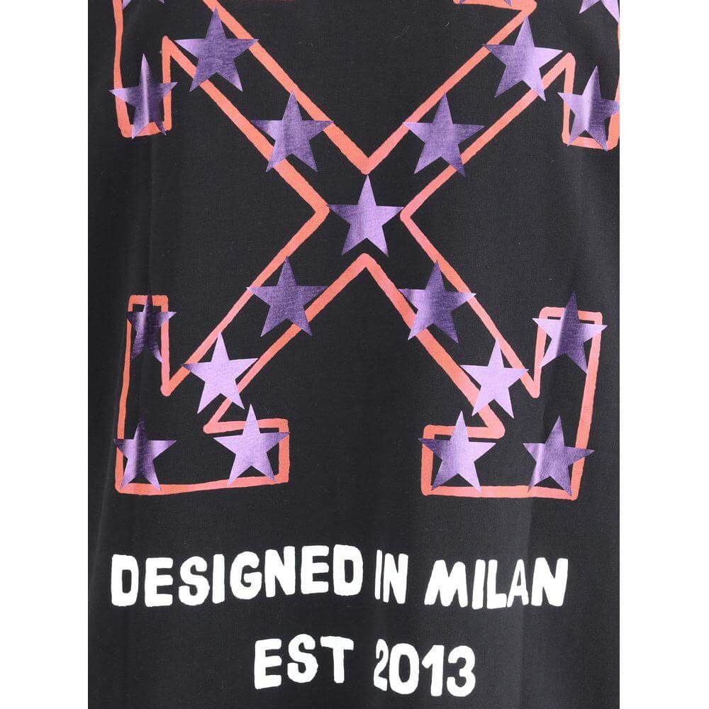 Close-up of Off-White Star Arrow T-Shirt with purple star pattern and 'Designed in Milan' text on black fabric.