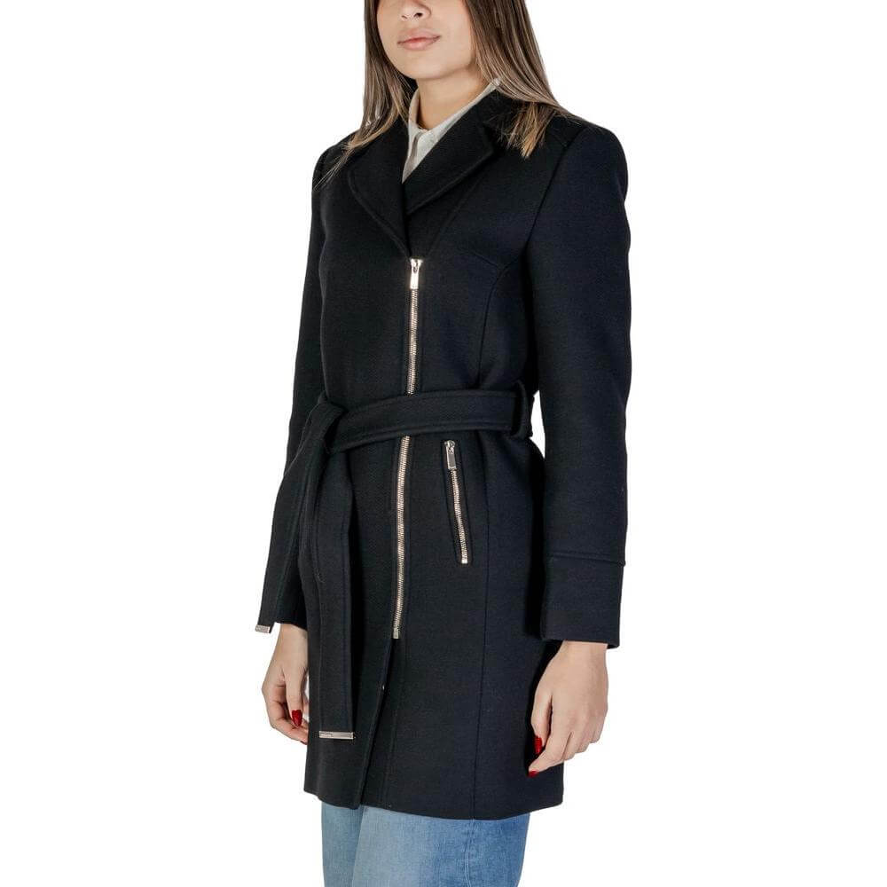 Woman wearing Morgan De Toi black wool jacket with belt, silver zippers; Fall/Winter women's coat, 60% wool composition.