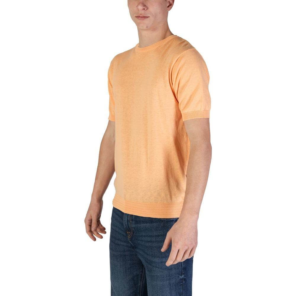 Model wearing Hamaki-Ho orange cotton t-shirt for men, fall/winter collection.
