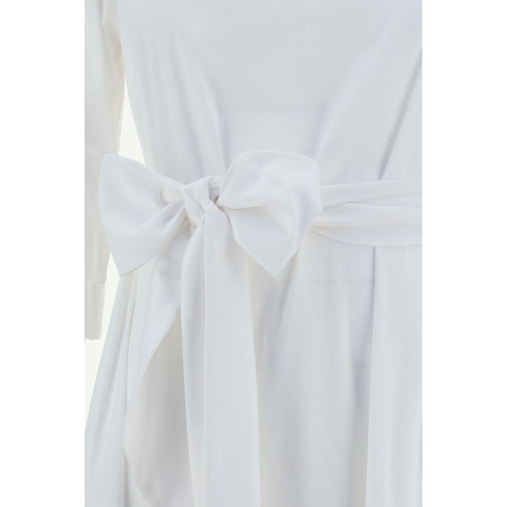 White Ella Long Dress with smocked waist, large bow tie, three-quarter sleeves, boat neckline, and embroidered hem detail.