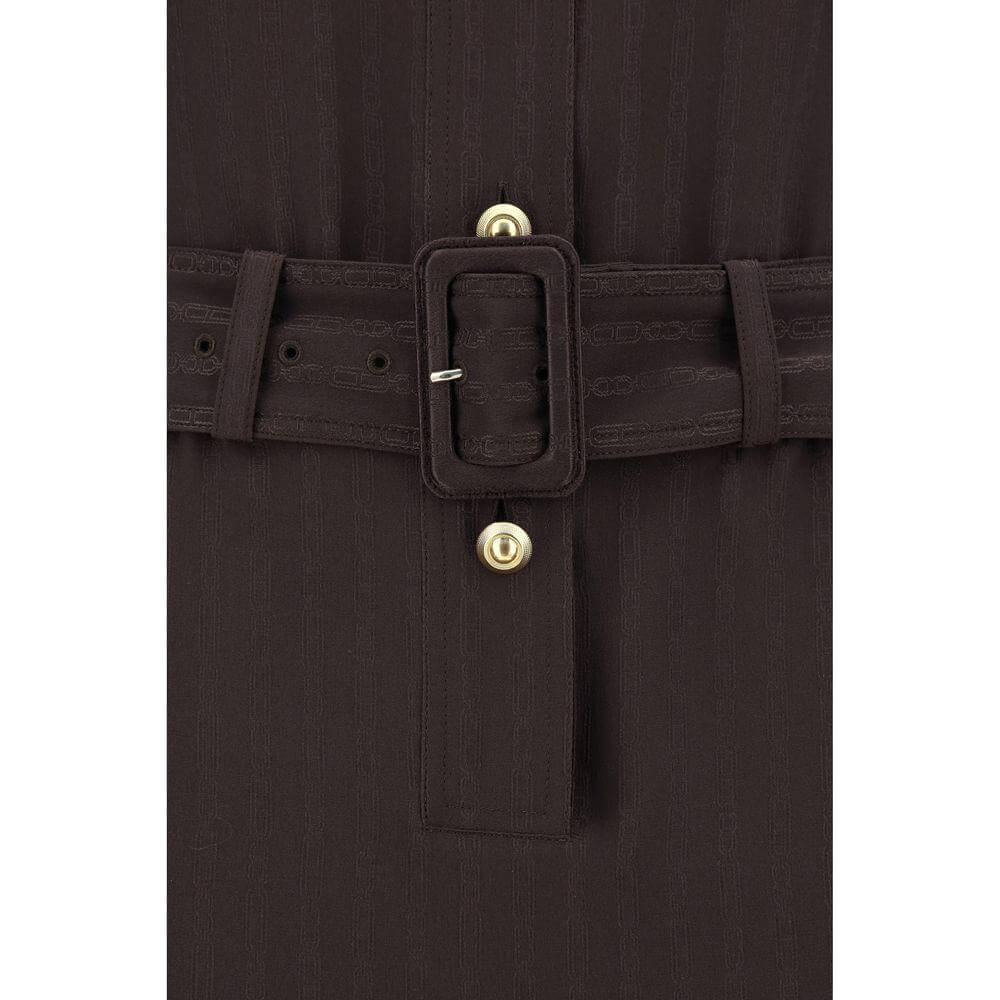 Close-up of Tom Ford long dress belt and button details in a dark fabric.