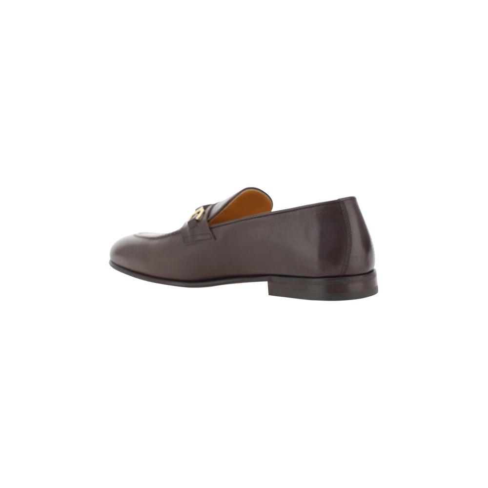 Brunello Cucinelli leather loafers with almond toe, embellished with antiqued brass detail, and block heel in shiny leather.