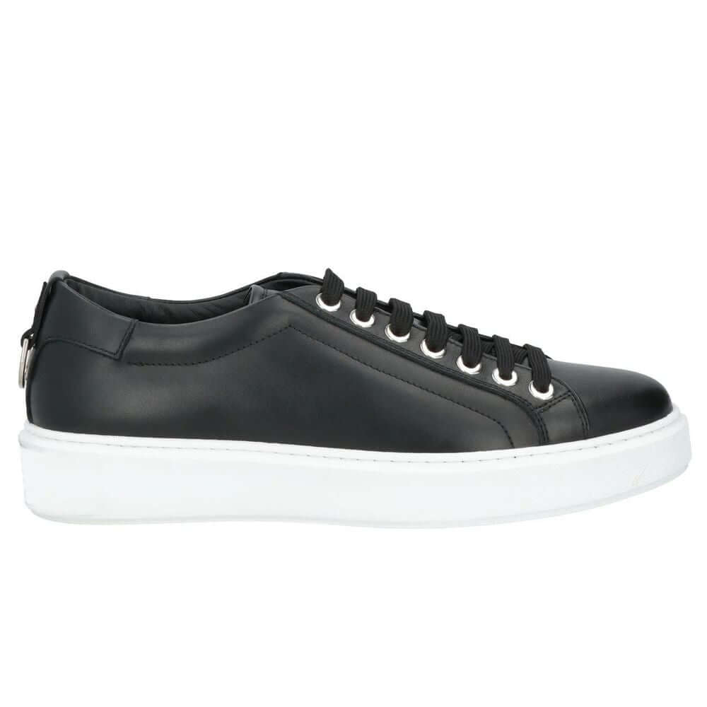 Les Hommes black calfskin men sneaker with silver logo tongue, decorative metal ring, and white rubber sole.