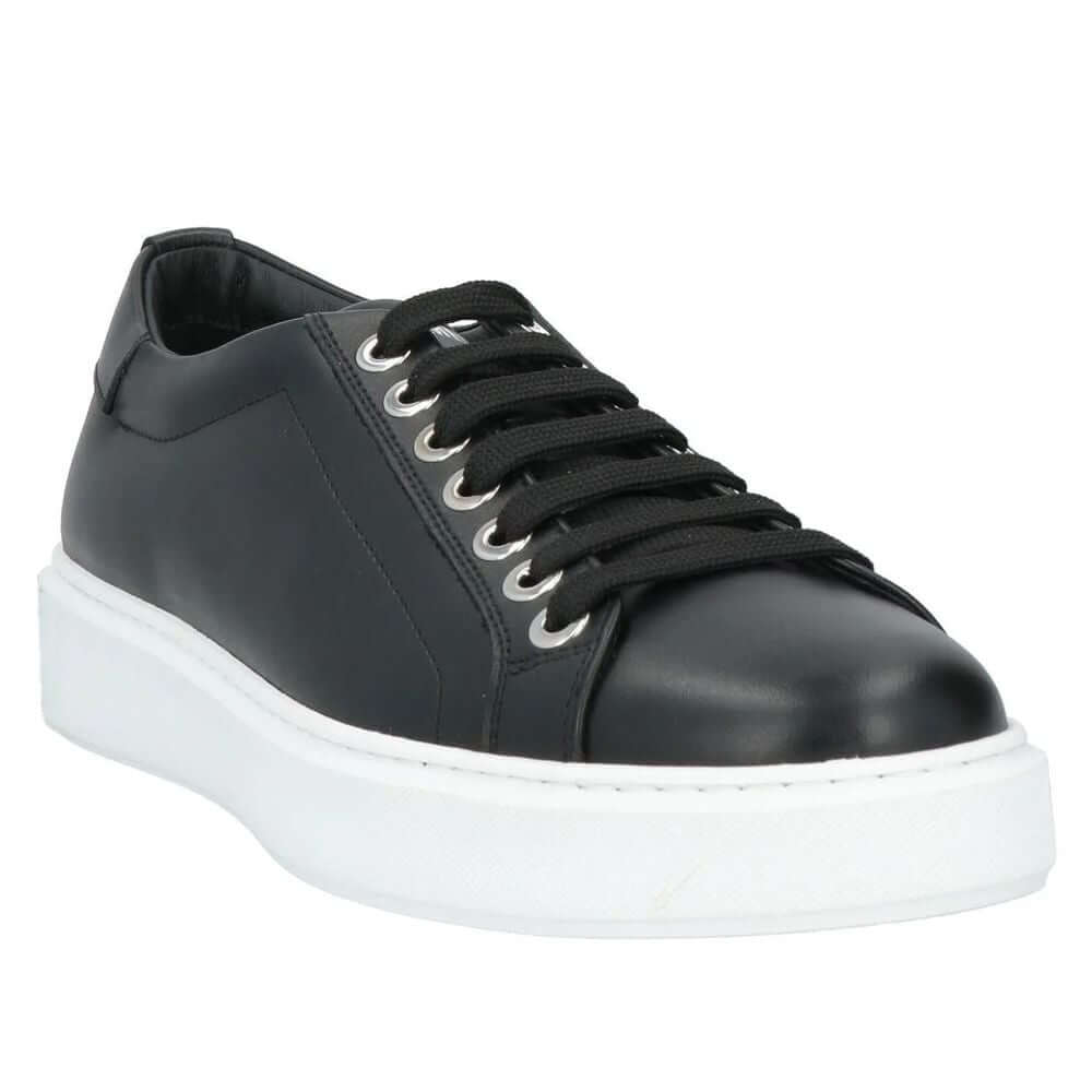 Les Hommes black calfskin sneaker with white sole and silver logo on tongue, crafted in Italy for luxurious style and comfort.