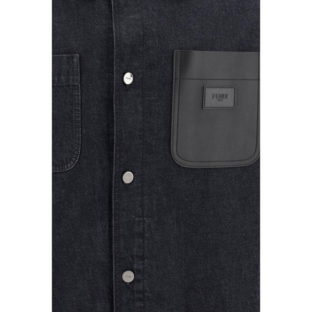 Close-up of Fendi denim jacket with leather pocket and logo, featuring snap-button closure and patch pocket details for a chic look.