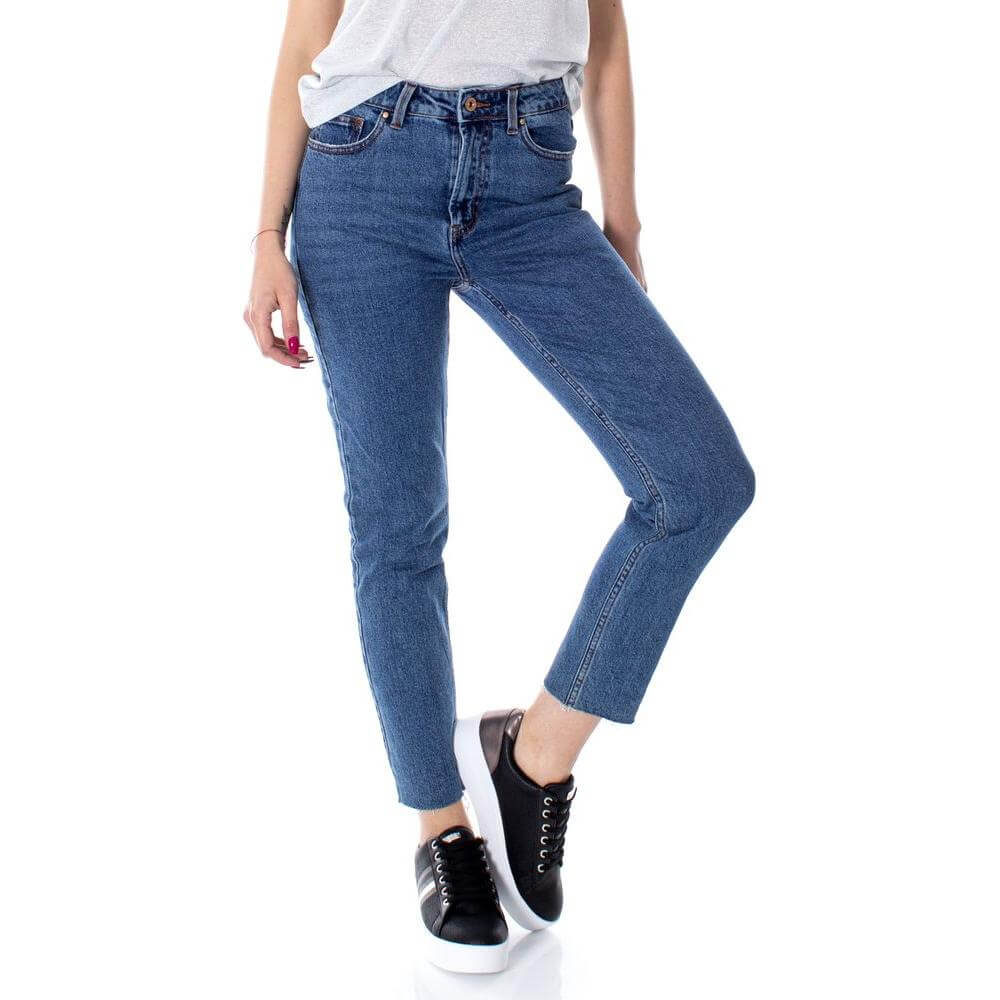 Woman wearing Only Blue Cotton Jeans with high waist and ankle length, styled casually with sneakers. Perfect for versatile occasions.
