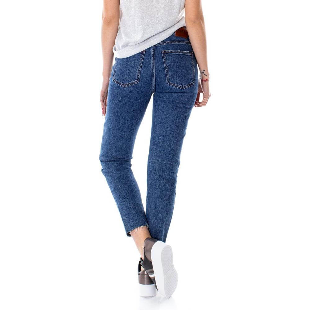 Back view of woman wearing Only blue cotton high waist ankle-length jeans, highlighting comfort and casual style.