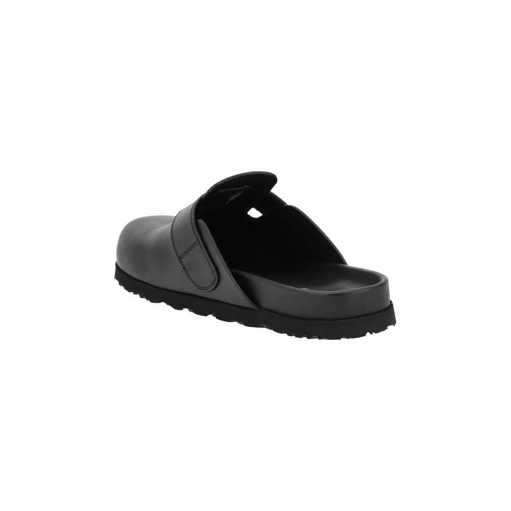 Rear view of Palm Angels black leather mules featuring a wide strap with a logo plaque and slip-on design for comfort and style.