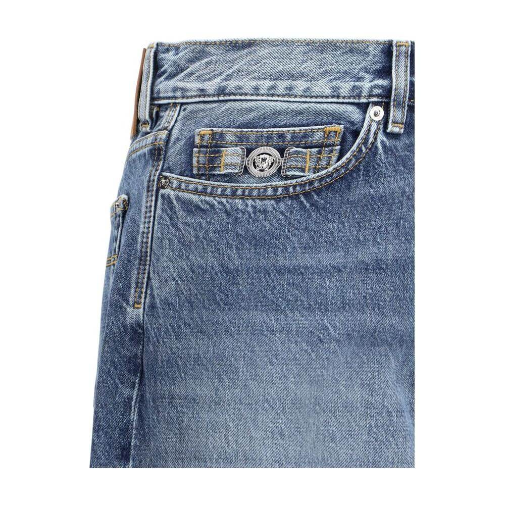Close-up of Versace Barocco Turn-Up Jeans showcasing five-pocket design and luxury Barocco pattern on waistband.