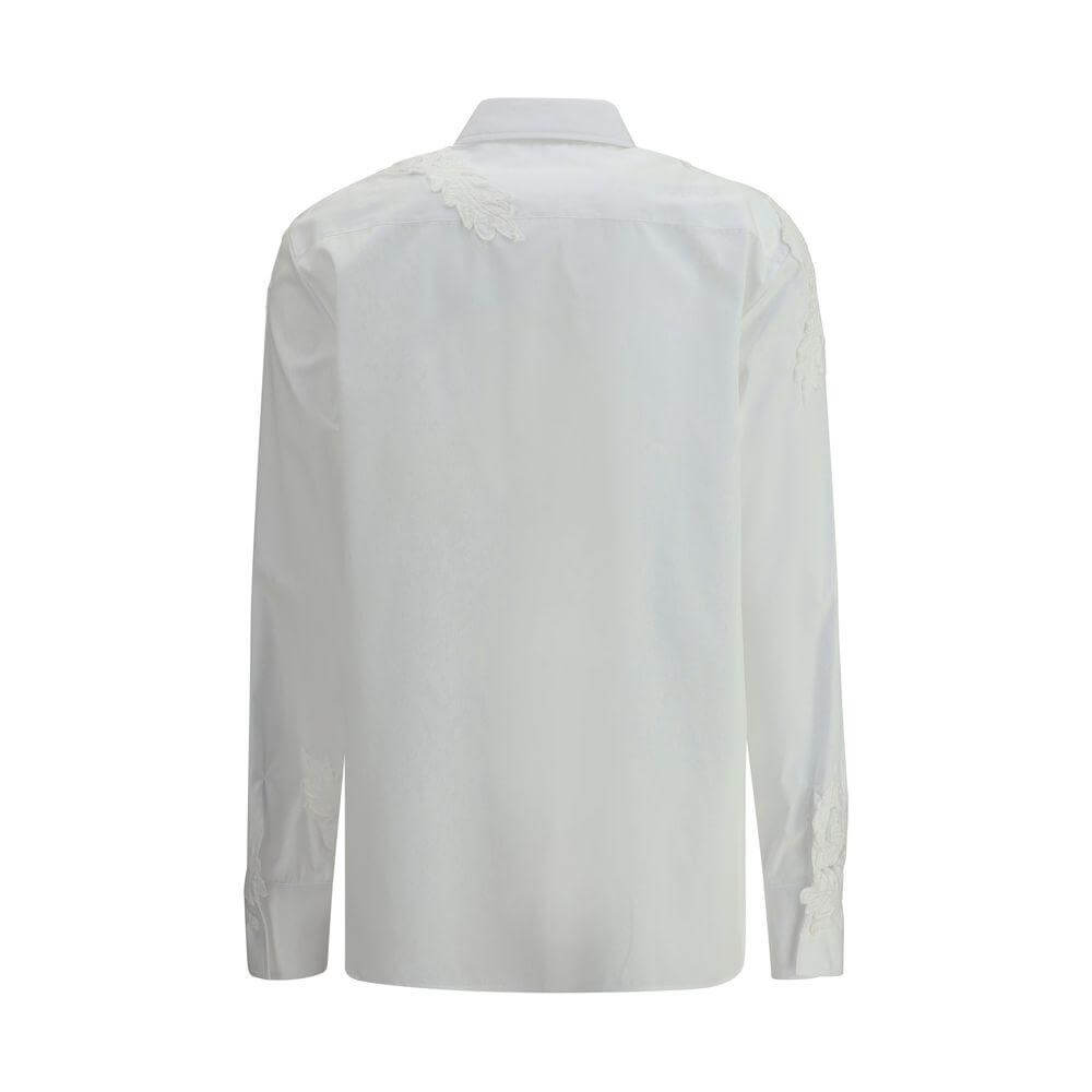 Rear view of Ermanno Scervino embroidered shirt with delicate floral details on shoulders, showcasing elegant craftsmanship.