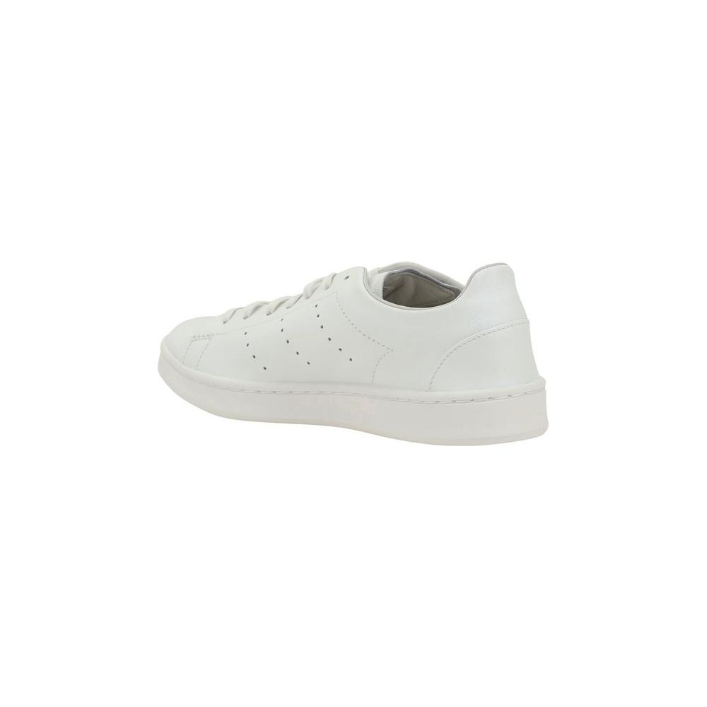Side view of Y-3 Stan Smith leather sneakers with perforated side panels and flat sole, featuring Yohji Yamamoto's signature on the heel.