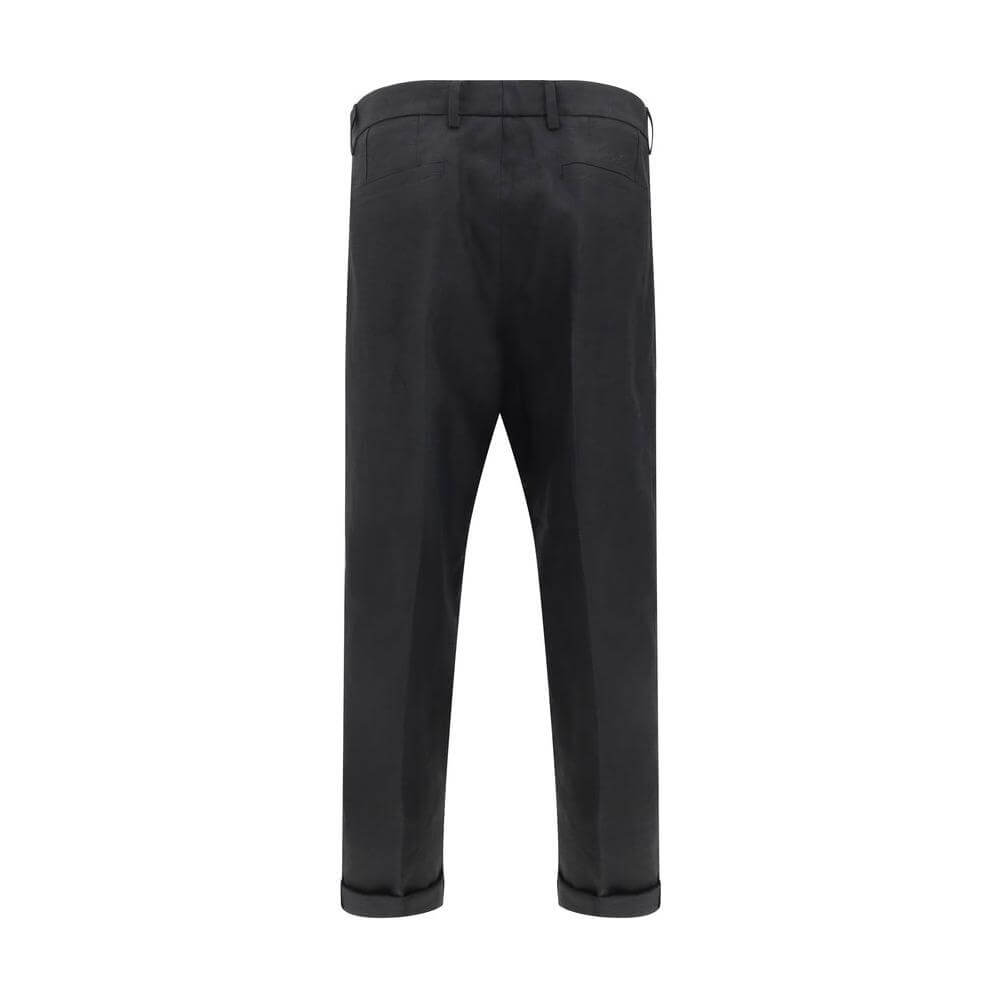 Back view of Dolce & Gabbana linen pants with tailored design and balloon leg silhouette, featuring welt pockets, zipper and button closure.