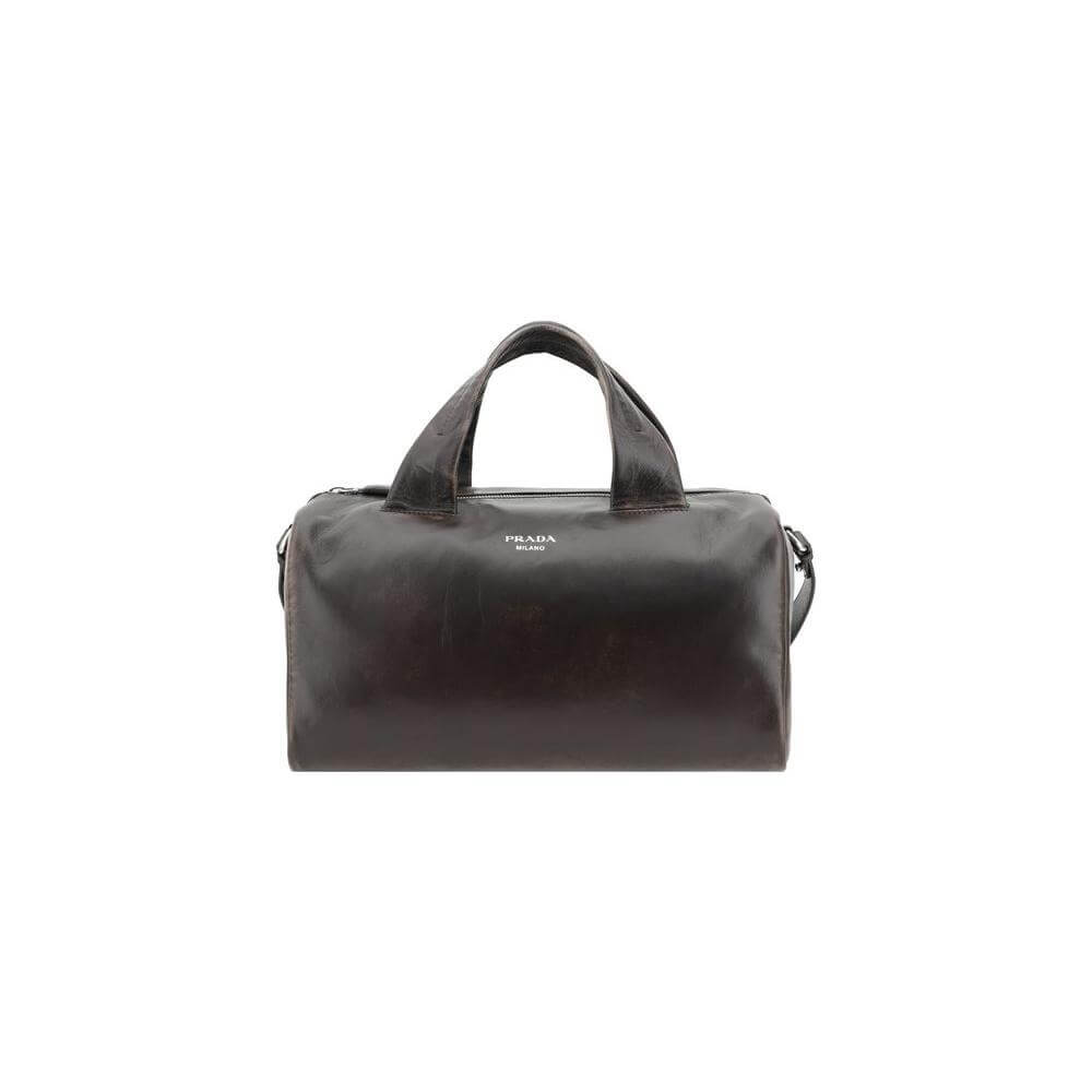 Prada leather men's travel bag with top zip closure, adjustable shoulder strap, and iconic monogram for luxury and versatility.