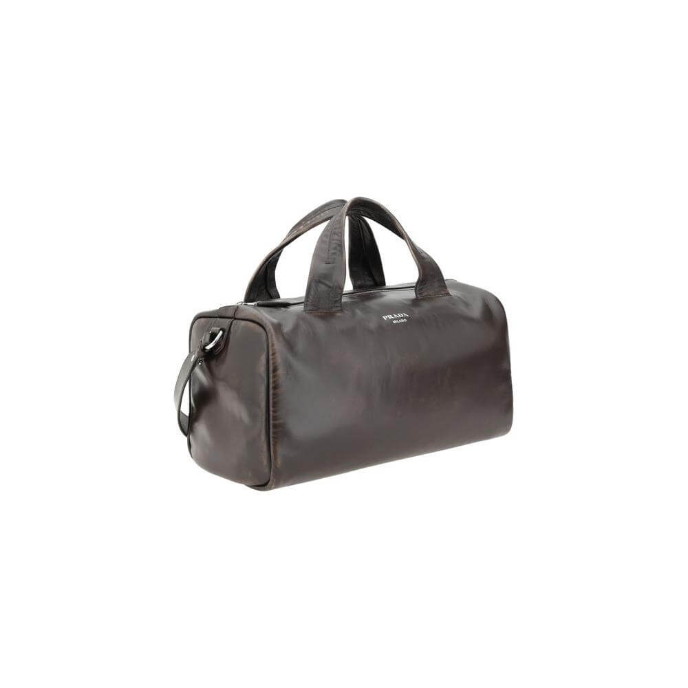 Prada leather men's travel bag in lambskin with top zip closure, comfortable handles, and adjustable shoulder strap for versatile use.