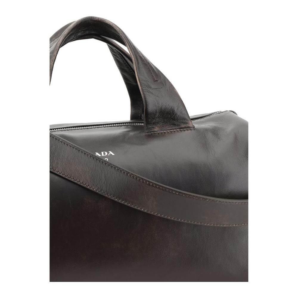Prada leather men's travel bag with top handles and iconic monogram, featuring an adjustable strap for versatile carrying options.