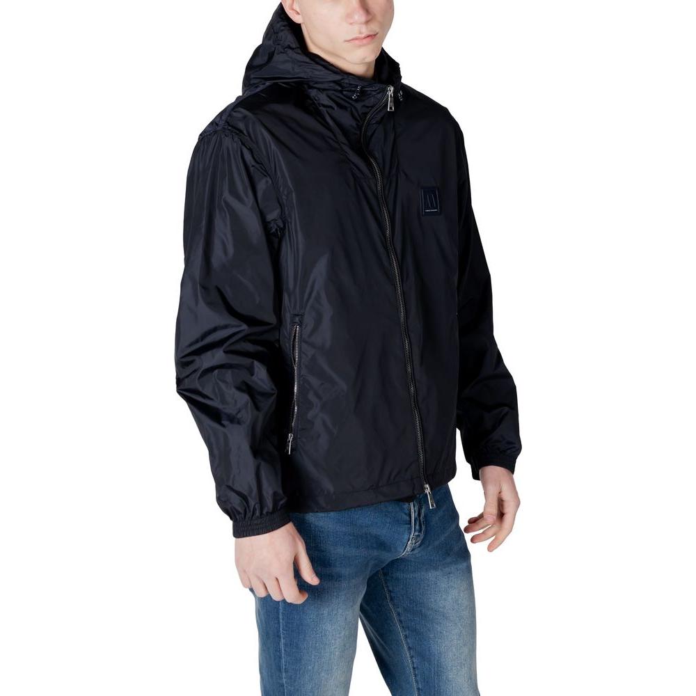 Armani Exchange black polyamide men's jacket with hood, modeled with jeans, front view. Stylish and lightweight outerwear for men.