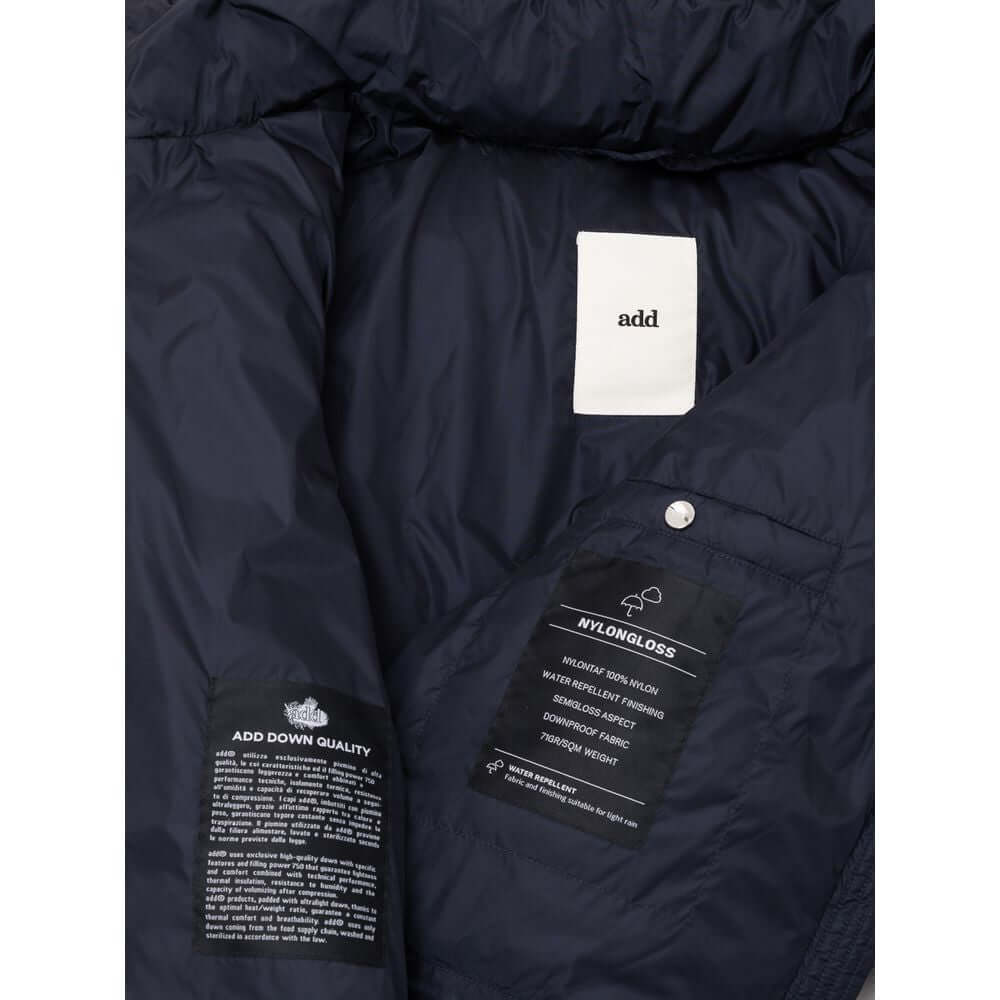Inner lining of blue polyamide jacket showcasing 'add' brand label and care instructions on black fabric.