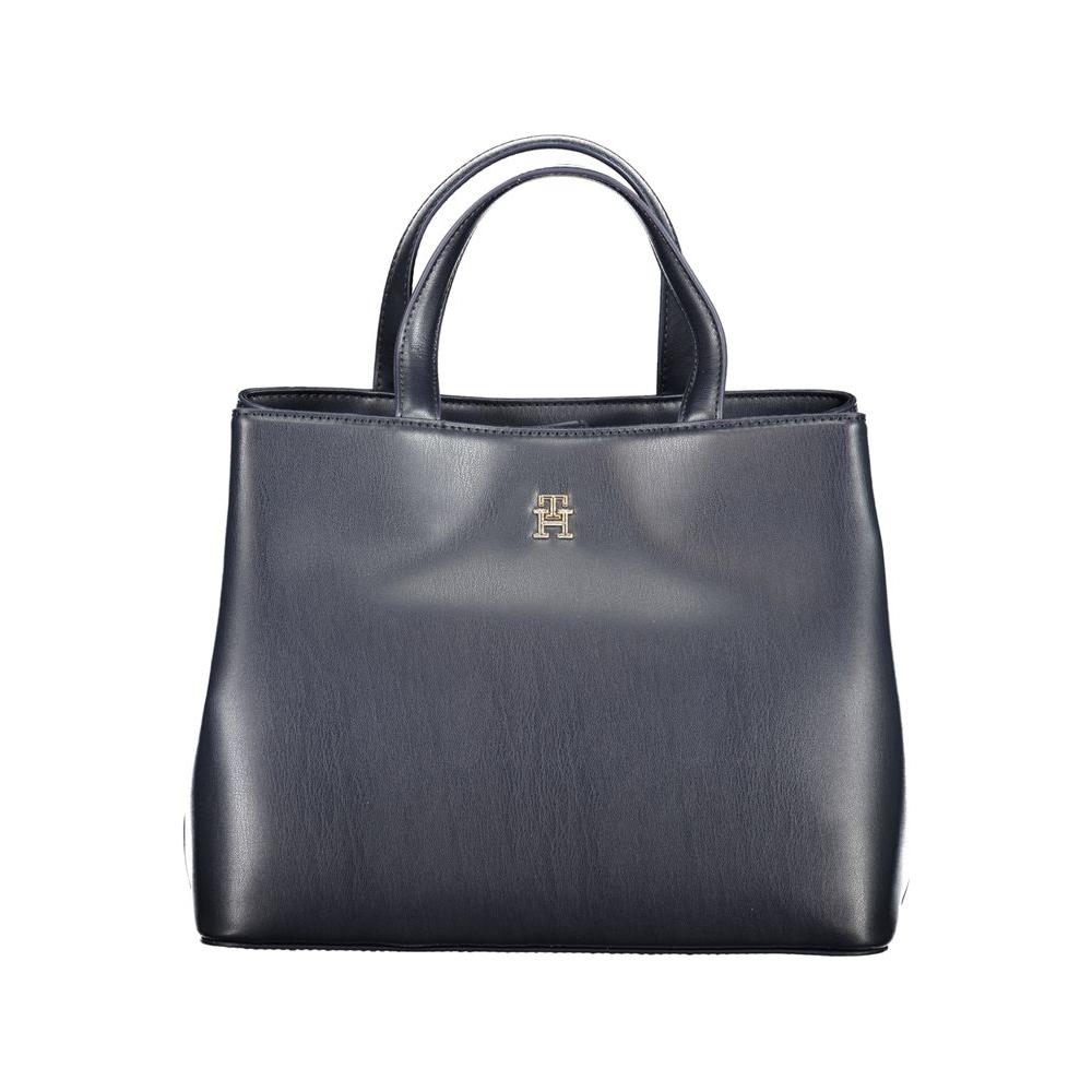 Tommy Hilfiger blue handbag with two handles, adjustable strap, internal and central pockets, snap closure, and logo detail.