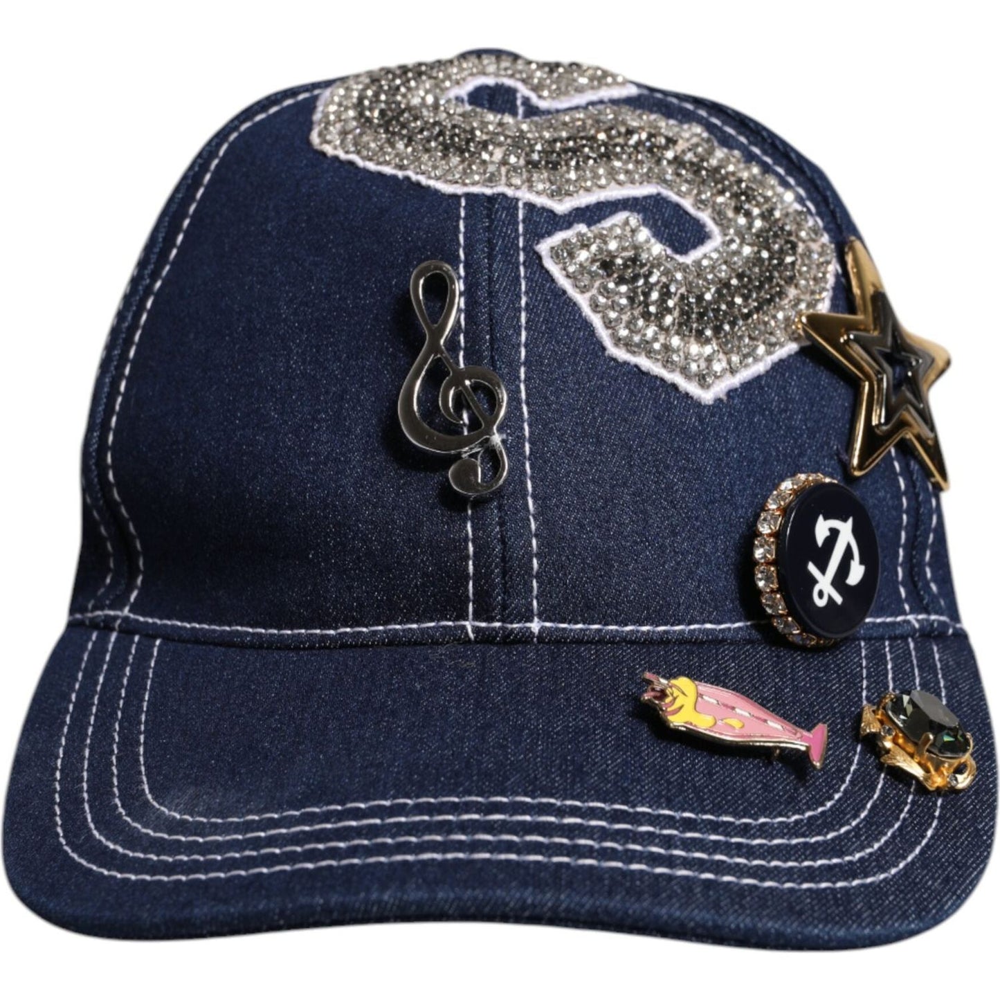Dolce & Gabbana blue baseball cap with crystal embellishments and decorative pins, including a musical note and stars.