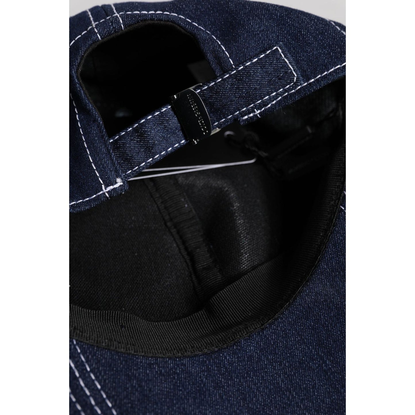 Inside view of Dolce & Gabbana blue crystal baseball cap showing adjustable strap and detailed stitching.