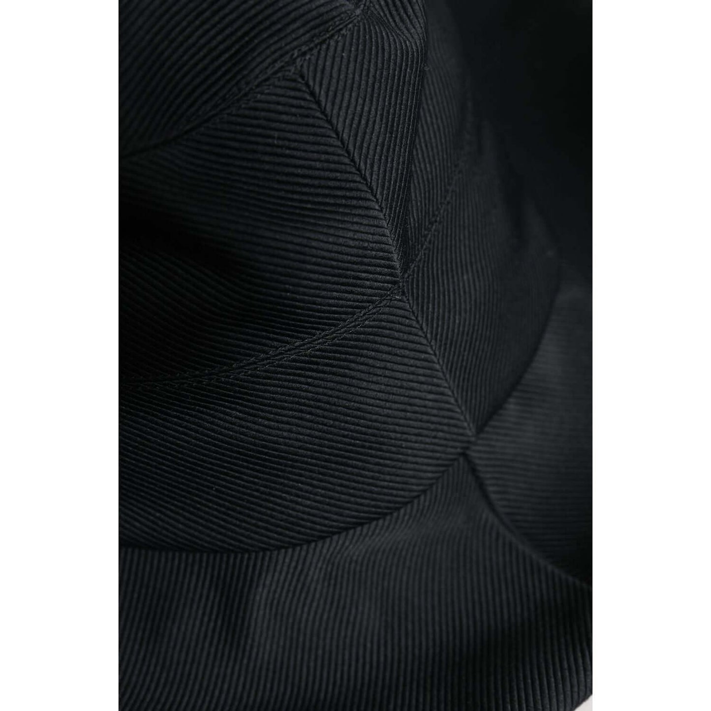 Close-up of Dolce & Gabbana black cotton wide brim fedora hat with silk lining, showcasing fine stitching details.