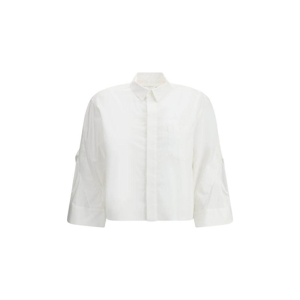 Sacai three-quarter sleeve cotton shirt with wide cuffs and classic collar, featuring a front button closure and welt breast pocket.