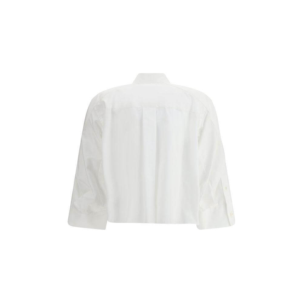 Back view of Sacai three-quarter sleeve cotton shirt with wide cuffs and classic collar, showcasing its contemporary and casual design.