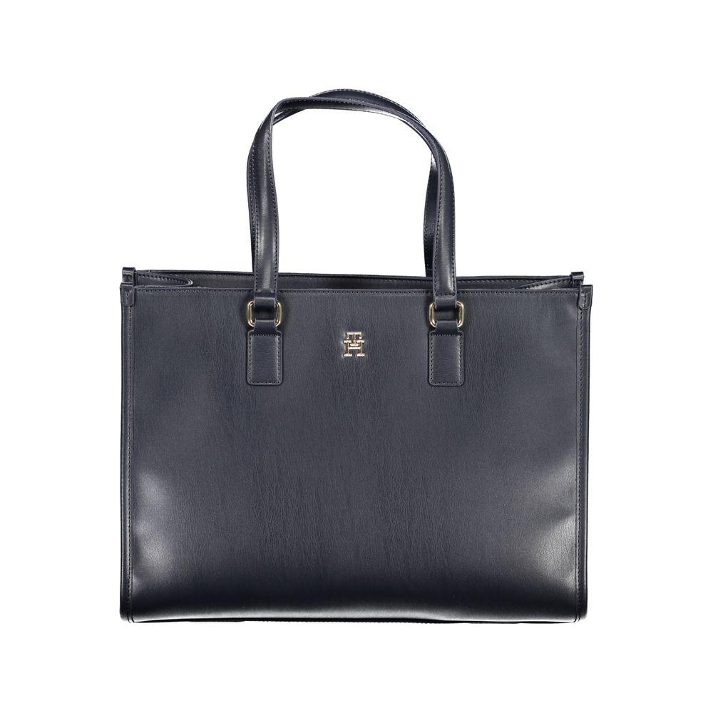 Tommy Hilfiger blue polyethylene handbag with dual shoulder handles, adjustable strap, internal pocket, zip closure, and logo.