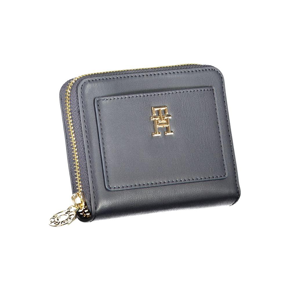 Tommy Hilfiger blue polyethylene wallet with zip closure, compartments, coin purse, card slots, external pocket, and logo.