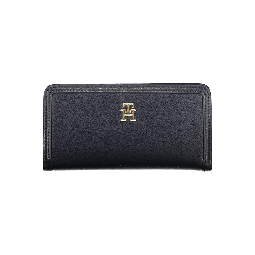 Tommy Hilfiger blue polyethylene wallet with logo, four compartments, external pocket, card slots, snap closure.