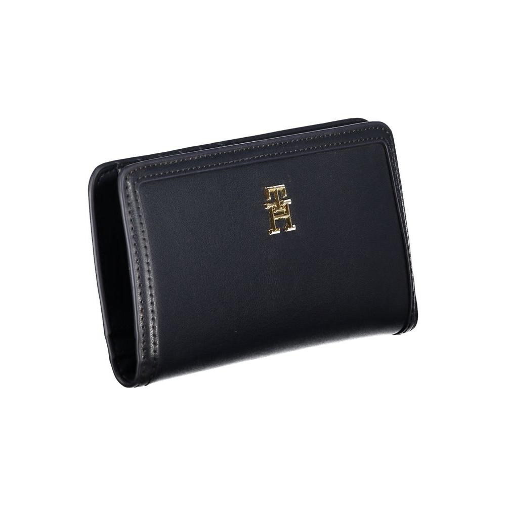 Tommy Hilfiger blue polyethylene wallet with logo, four compartments, external pocket, card spaces, and snap closure.