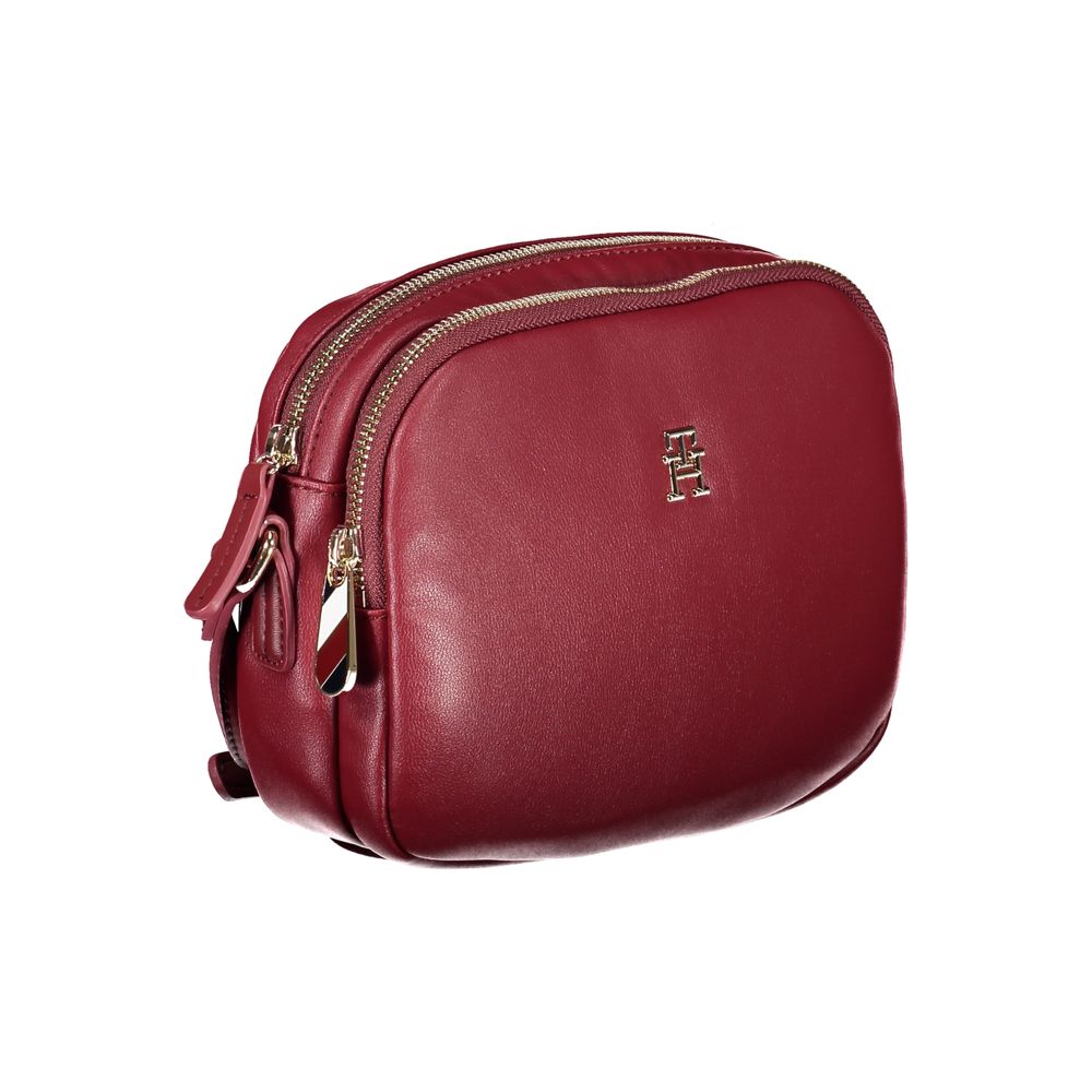 Tommy Hilfiger Red Polyester Handbag with adjustable strap, two compartments, internal pocket, and zip closure.