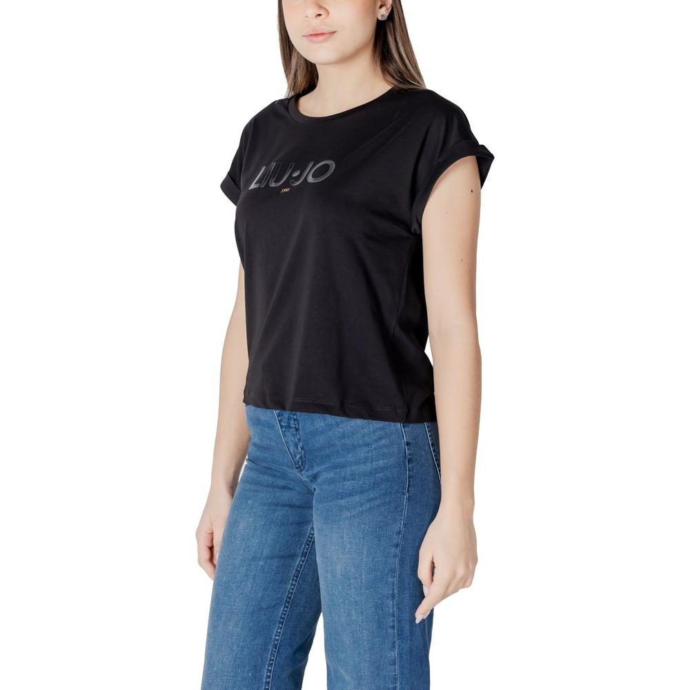 Woman wearing Liu Jo black cotton t-shirt with short sleeves, paired with jeans for a casual yet elegant look.