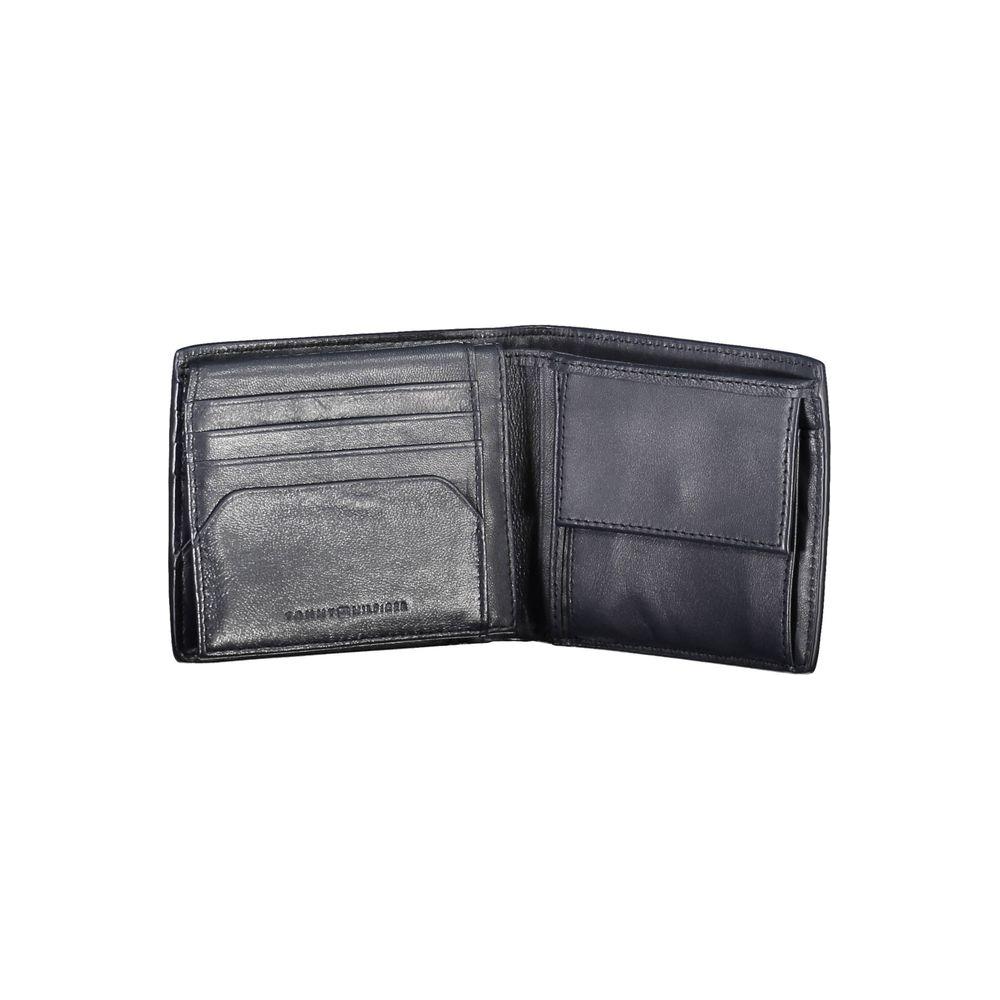 Tommy Hilfiger blue leather men's wallet open showing card slots and coin purse, elegant design with iconic logo.