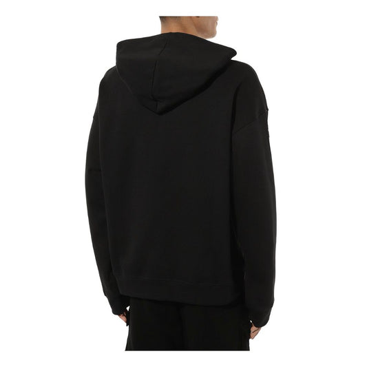 Back view of Comme Des Fuckdown black cotton hoodie with attached hood.