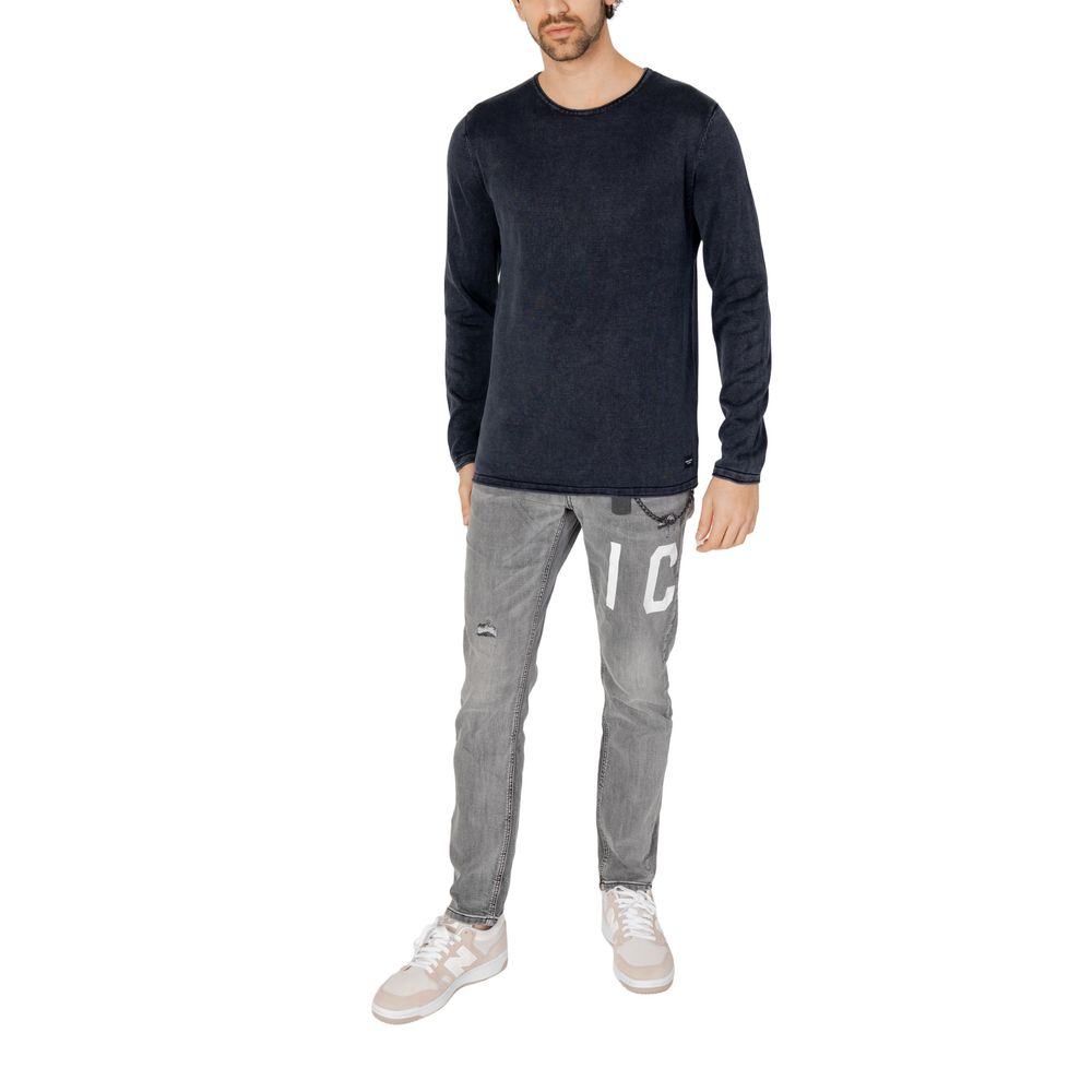 Man wearing Jack Jones Blue Cotton Sweatshirt with gray jeans and white sneakers, showcasing a casual refined look.