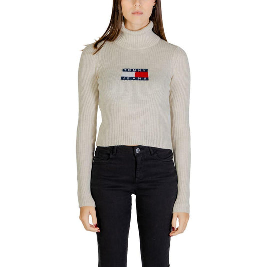 Model wearing Tommy Hilfiger Women's Beige Recycled Polyester Sweater from Fall/Winter collection, featuring ribbed design.